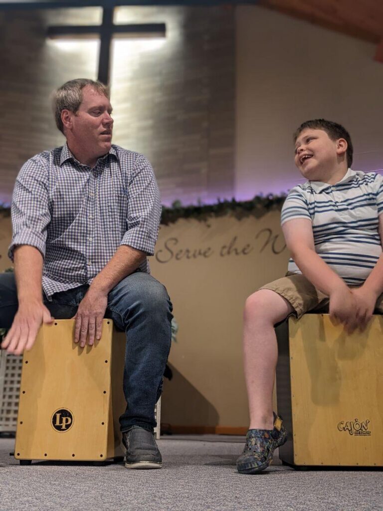 pastor Adam and his son playing floor drums